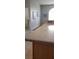 Kitchen counter featuring neutral granite countertops, cabinets, and views of other rooms at 3700 Plantation Blvd, Leesburg, FL 34748
