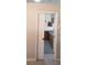 Bright kitchen features a tile floor and cabinets, seen through a doorway at 3700 Plantation Blvd, Leesburg, FL 34748