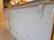 Kitchen island with white beadboard siding and granite countertops at 3700 Plantation Blvd, Leesburg, FL 34748