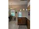 Kitchen area with pendant lights, island, and view to the backyard at 3700 Plantation Blvd, Leesburg, FL 34748