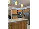 Kitchen with wood cabinets, granite countertops, and stainless steel appliances at 3700 Plantation Blvd, Leesburg, FL 34748