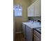 Laundry room featuring a modern washer and dryer and storage cabinets at 3700 Plantation Blvd, Leesburg, FL 34748