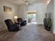 Bright living room with cozy seating, a ceiling fan, and a view of the sunroom at 3700 Plantation Blvd, Leesburg, FL 34748