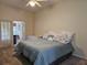 Bedroom featuring a large bed and an ensuite bathroom at 3700 Plantation Blvd, Leesburg, FL 34748