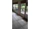 Enclosed patio with tile floors, outdoor cooking area, and view of the lush backyard at 3700 Plantation Blvd, Leesburg, FL 34748
