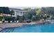 Relaxing pool area with waterfall features and a view of the clubhouse and lush landscaping at 3700 Plantation Blvd, Leesburg, FL 34748
