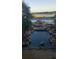 Scenic view of the pool area with rock features and a bridge overlooking the serene lake at 3700 Plantation Blvd, Leesburg, FL 34748