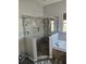 A modern bathroom shower features gray tile surround and glass door at 3700 Plantation Blvd, Leesburg, FL 34748