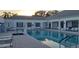 This image showcases a community pool with lounge chairs and tables for residents to relax and enjoy at 3700 Plantation Blvd, Leesburg, FL 34748