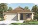 Charming single-story home featuring a two-car garage, well-manicured lawn, and tropical landscaping at 4493 Yaupon Holly Way, Lakeland, FL 33811