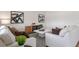 Comfortable living room featuring neutral tones, modern artwork, and a plush sofa arrangement at 4493 Yaupon Holly Way, Lakeland, FL 33811