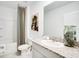 Bathroom featuring granite countertops, a tub with a colorful curtain, and white cabinets at 4760 Yellow Elder Way, Kissimmee, FL 34758