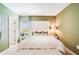 Comfortable bedroom with soft green walls, a large bed, and neutral decor at 4760 Yellow Elder Way, Kissimmee, FL 34758