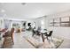 Elegant dining area with a modern dining table, and seamless transition to the living room at 4760 Yellow Elder Way, Kissimmee, FL 34758