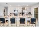 Modern kitchen featuring stainless steel appliances, a large island, and an adjacent pantry at 4760 Yellow Elder Way, Kissimmee, FL 34758