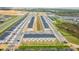 Expansive aerial view showcasing a new townhome community, highlighting the layout, landscaping, and modern construction at 502 Bogey Dr, Davenport, FL 33896