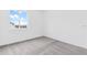 This bedroom has neutral gray carpet, white walls, and a window at 502 Bogey Dr, Davenport, FL 33896
