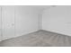 This bedroom has neutral gray carpet, white walls, and two entry doors at 502 Bogey Dr, Davenport, FL 33896