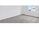 This bedroom has neutral gray carpet, white walls, and a window at 502 Bogey Dr, Davenport, FL 33896