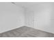 This bedroom has neutral gray carpet and white walls with two entry doors at 502 Bogey Dr, Davenport, FL 33896