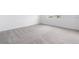 Clean bedroom features neutral carpeting and a light interior with a window providing natural light at 502 Bogey Dr, Davenport, FL 33896