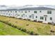 Charming row of newly built townhomes with freshly landscaped yards and modern white facades, great for modern living at 502 Bogey Dr, Davenport, FL 33896