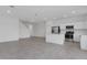Spacious living room showcasing an open floor plan with tile flooring, recessed lighting, and kitchen access at 502 Bogey Dr, Davenport, FL 33896