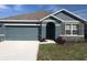 Charming single-Gathering home features a gray exterior, attached garage and manicured lawn at 5067 Tana Ter, St Cloud, FL 34772