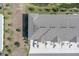 Bird's eye view of a townhome's roof, landscaping, parking, and surrounding community at 5214 Dragonfly Dr, Wildwood, FL 34785