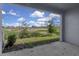 Outdoor back porch with an exterior view of a landscaped yard at 5214 Dragonfly Dr, Wildwood, FL 34785