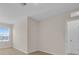 Bedroom with a bright window featuring outside views and an entry door at 5214 Dragonfly Dr, Wildwood, FL 34785