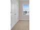 Carpeted bedroom featuring a bright window and a closet at 5214 Dragonfly Dr, Wildwood, FL 34785