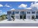 Gray two-story townhome with attached garage and driveway parking in a residential neighborhood at 5214 Dragonfly Dr, Wildwood, FL 34785