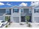 Charming townhome with a gray exterior, attached garage, and well-maintained landscaping at 5214 Dragonfly Dr, Wildwood, FL 34785