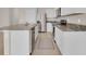 Bright kitchen features stainless steel appliances, granite countertops, and white cabinetry at 5214 Dragonfly Dr, Wildwood, FL 34785