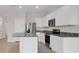 Modern kitchen with stainless steel appliances, white cabinets, and stylish gray granite countertops at 5214 Dragonfly Dr, Wildwood, FL 34785