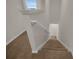 Carpeted staircase with white railing leading to the upper level of the home at 5214 Dragonfly Dr, Wildwood, FL 34785