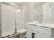 Modern bathroom with a white vanity, quartz countertop, glass-enclosed shower and tile floors at 5242 Citrus Leaf, Winter Garden, FL 34787