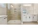 Modern bathroom featuring a glass shower with tiled walls and double sink vanity at 5242 Citrus Leaf, Winter Garden, FL 34787