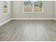A bright bedroom with wood-look tile flooring and natural light from the windows at 5242 Citrus Leaf, Winter Garden, FL 34787