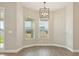 A cozy dining area featuring two windows and a contemporary light fixture at 5242 Citrus Leaf, Winter Garden, FL 34787