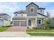 Charming two-story home features a brick driveway, a two-car garage, and well-maintained landscaping at 5242 Citrus Leaf, Winter Garden, FL 34787