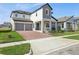Attractive home boasts a brick driveway, a two-car garage, and neat landscaping at 5242 Citrus Leaf, Winter Garden, FL 34787