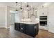 Modern kitchen with stainless steel appliances, white cabinets, and a center island at 5242 Citrus Leaf, Winter Garden, FL 34787