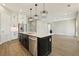 Bright kitchen featuring an island, stainless steel appliances, white cabinets, and wood-look tile flooring at 5242 Citrus Leaf, Winter Garden, FL 34787