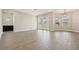 Spacious living room with wood-look tile floors and ample natural light at 5242 Citrus Leaf, Winter Garden, FL 34787