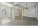 Bright living room featuring an open floor plan and wood-look tile flooring at 5242 Citrus Leaf, Winter Garden, FL 34787