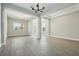 Bright, spacious living room featuring an open floor plan with wood-look tile flooring at 5242 Citrus Leaf, Winter Garden, FL 34787