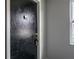 Apartment door with a security system, deadbolt lock, the number 202 and a small window at 5325 Curry Ford Rd # G202, Orlando, FL 32812