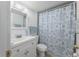 Bathroom with white vanity, toilet, and shower featuring a decorative turtle shower curtain at 5325 Curry Ford Rd # G202, Orlando, FL 32812